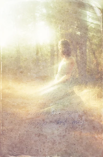 Surreal blurred background of young woman sitting on the tsone in forest — Stock Photo, Image