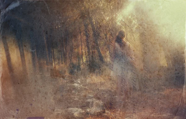 Surreal blurred background of young woman stands in forest. abstract and dreamy concept. image is textured and retro toned — Stock Photo, Image