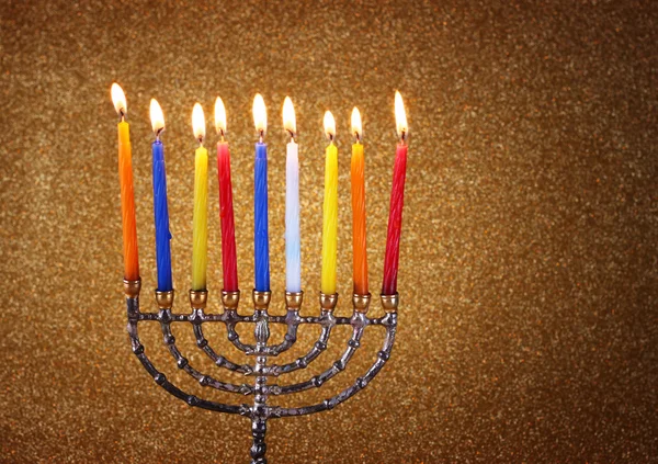 Menorah with candels and glitter lights background. hanukkah concept