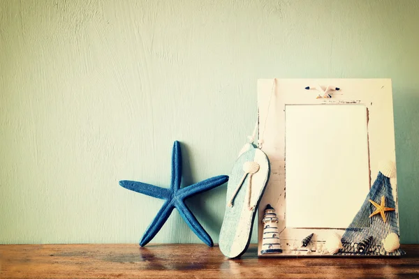 Vintage nautical frame on wooden table. retro filtered image — Stock Photo, Image