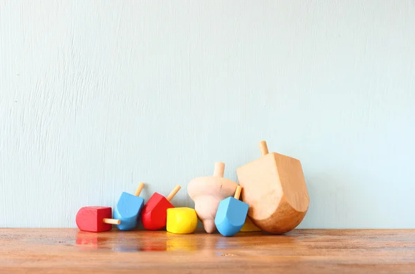 Wooden dreidels for hanukkah (spinning top) over wooden background — Stock Photo, Image