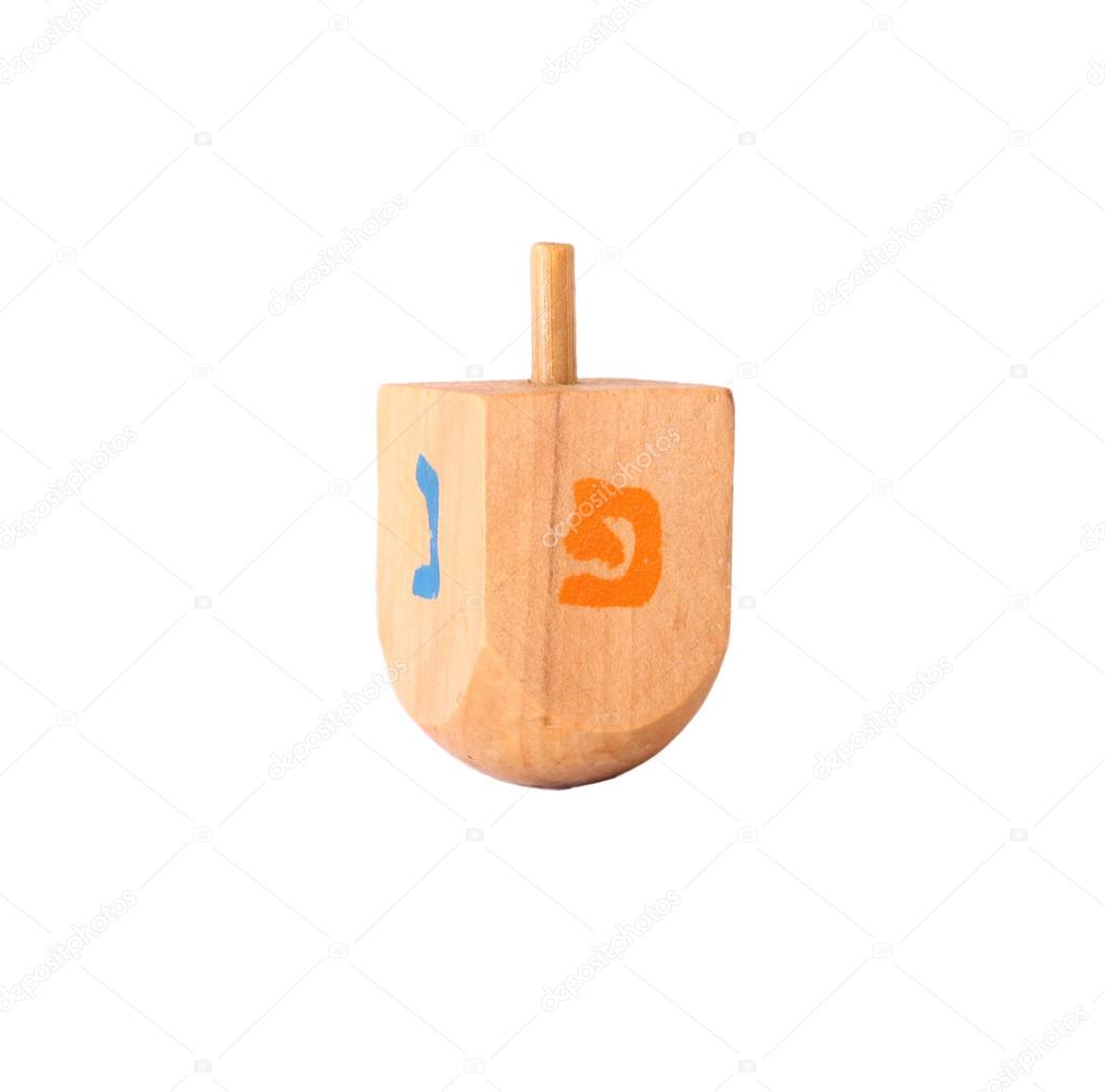 Wooden dreidel (spinning top) for hanukkah jewish holiday isolated on white
