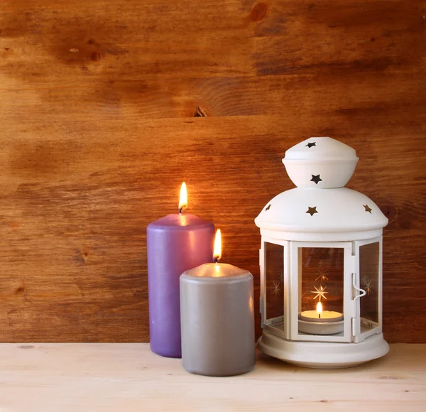 Linterna Vintage con vela encendida sobre mesa de madera. imagen filtrada —  Fotos de Stock