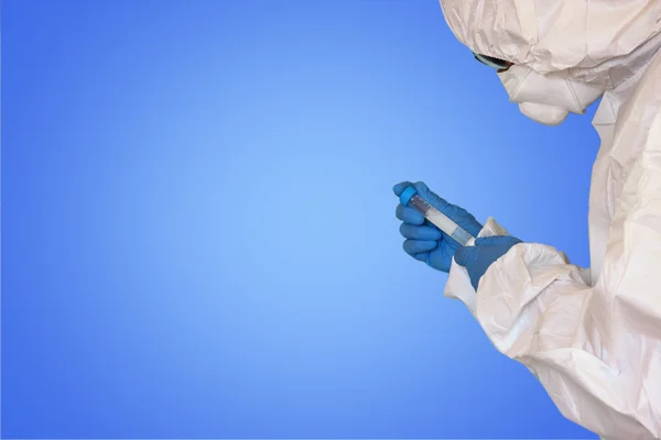 Lab scientist in safety suit With test tube. selective focus — Stock Photo, Image