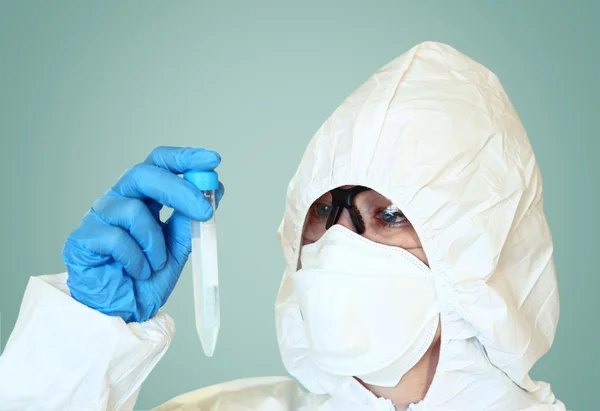 Lab scientist in safety suit With test tube. selective focus — Stock Photo, Image