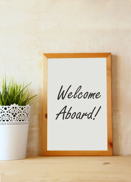 Drawing board with the phrase welcome aboard handwritten over wooden table. — Stock Photo, Image