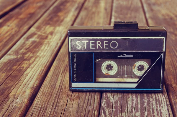 Old portable cassette player on a wooden background. image is instagram style filtered — Stock Photo, Image