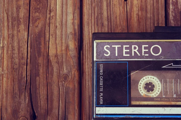 Old portable cassette player on a wooden background. image is instagram style filtered — Stock Photo, Image