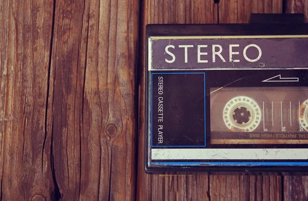 Old portable cassette player on a wooden background. image is instagram style filtered — Stock Photo, Image