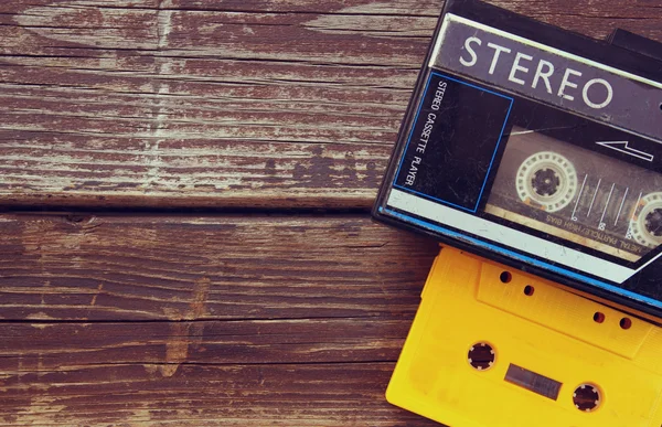 Old portable cassette player on a wooden background. image is instagram style filtered — Stock Photo, Image