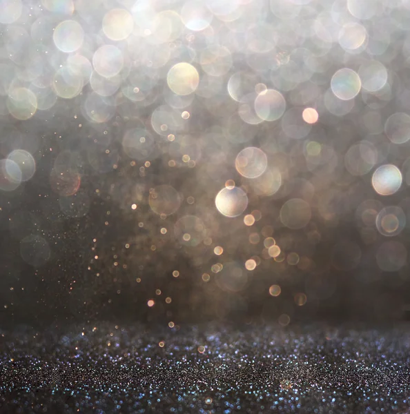 Glitter vintage lights background. gold, silver, and black. de-focused. — Stock Photo, Image