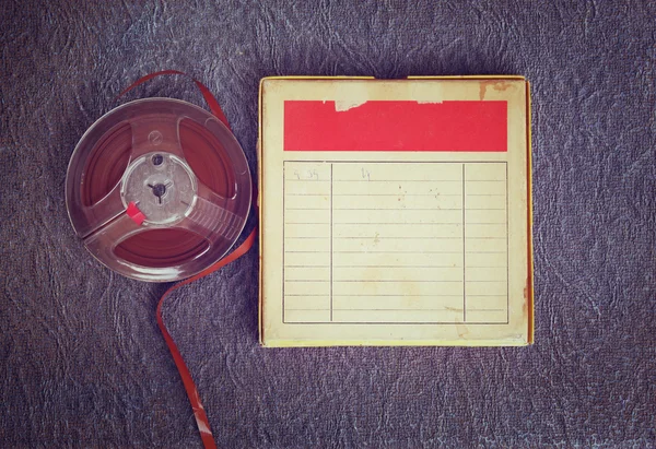Top view of  old sound recording tape, reel to reel type and box with room for text. filtered image — Stock Photo, Image
