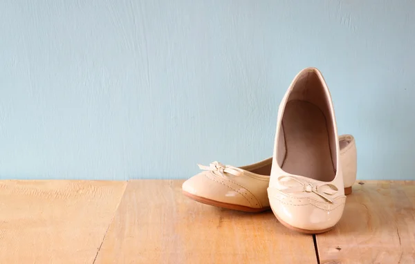 Girl shoes over wooden deck floor. — Stock Photo, Image