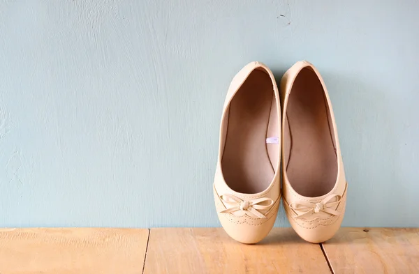 Girl shoes over wooden deck floor. — Stock Photo, Image