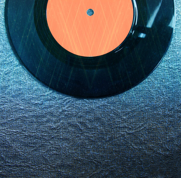 Top view of record over textured background and glitter lights