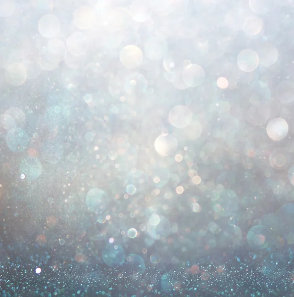 Glitter vintage lights background with light burst . silver, blue and white. de-focused. — Stock Photo, Image