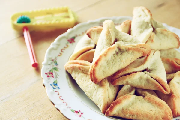 Hamantaschen cookies of hamans oren en noisemaker voor Purim viering (Joodse vakantie) — Stockfoto