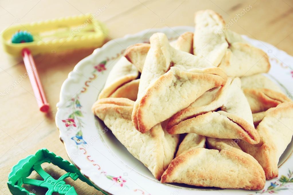 Hamantaschen cookies or hamans ears and noisemaker for Purim celebration (jewish holiday)