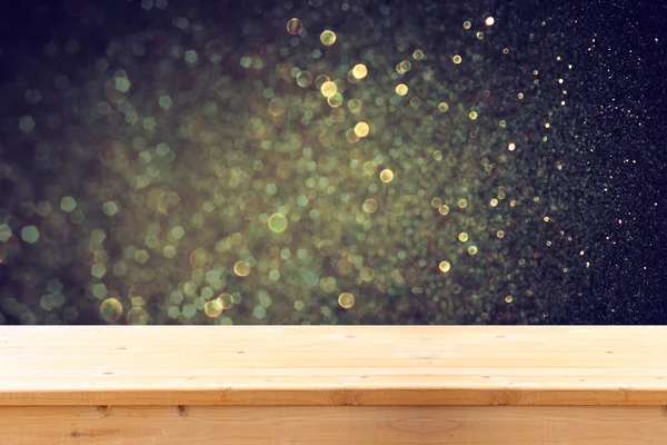 Rustic wood table in front of glitter gold bright bokeh lights — Stock Photo, Image