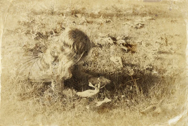 Niedliches kleines Mädchen, das im Garten spielt. gefiltertes Bild, altes Foto — Stockfoto