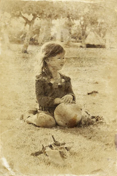 Cute little girl playing in the garden. filtered image, old style photo — Stock Photo, Image