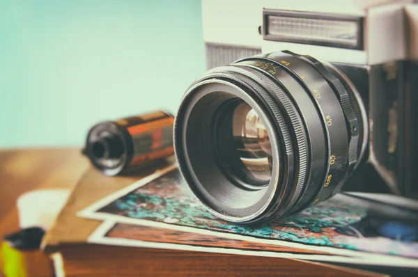 Fermer la photo de l'objectif vieil appareil photo sur une table en bois. image est rétro filtrée. focus sélectif — Photo