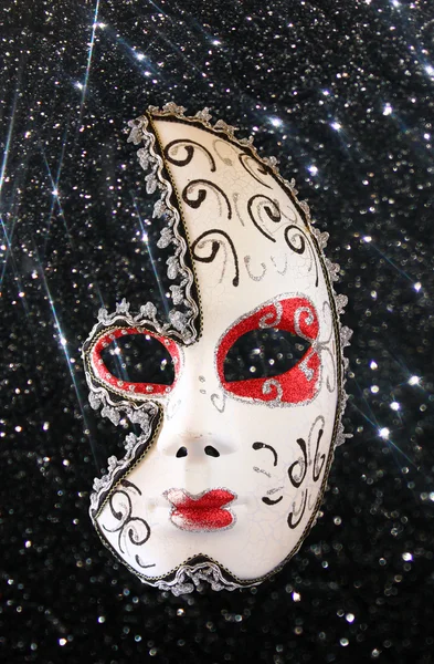 Dramatic and mysterious half moon carnival mask and black glitter background — Stock Photo, Image