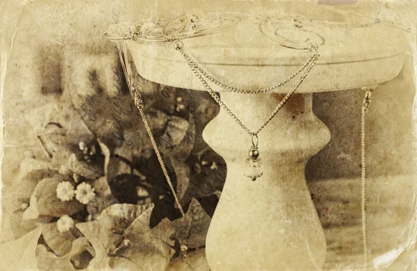 Black and white photo of antique vintage necklace on wooden table. — Stock Photo, Image