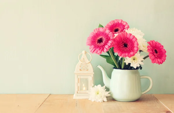 Summer  bouquet of flowers and lantern on the wooden table with mint background. vintage filtered image — Stock Photo, Image