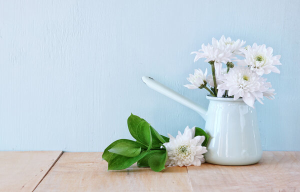 Summer bouquet of flowers on the wooden table with mint background. vintage filtered image