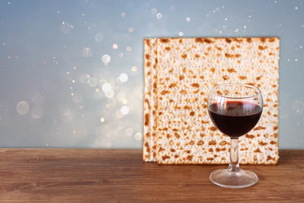 Pesach pozadí. víno a matzoh (židovský Pesach chléb) pozadí modré třpytky. — Stock fotografie