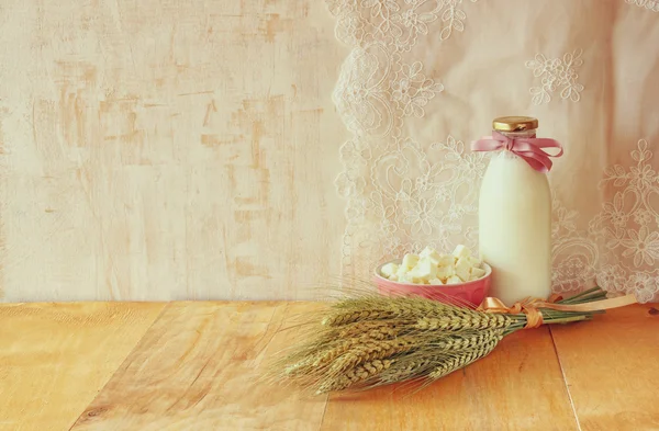 Greek cheese , bulgarian cheese and milk on wooden table over wooden textured background. Symbols of jewish holiday - Shavuot — Stock Photo, Image