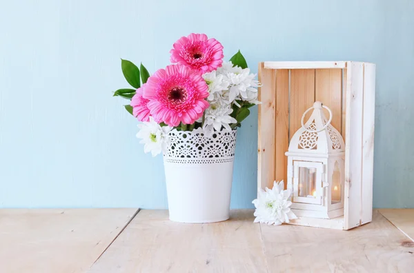 Summer bouquet of flowers and vintage lantern on the wooden table with mint background. vintage filtered image — Stock Photo, Image