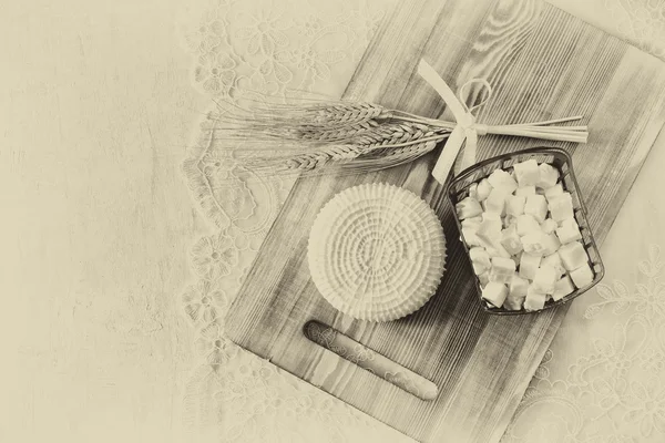 Image of greek cheese and bulgarian cheese on wooden table over wooden textured background. Symbols of jewish holiday - Shavuot. Black and white style photo. — Stock Photo, Image