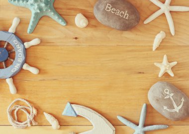 Deniz topluluğu ve plaj nesneleri ahşap arka plan üzerinde bir çerçeve oluşturma,