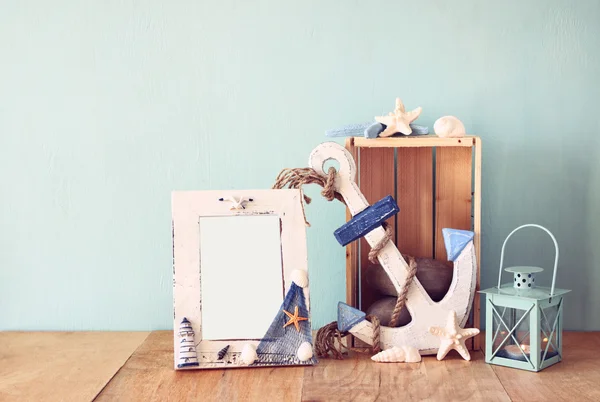 Old nautical frame with wooden anchor on wooden table. vintage filtered image — Stock Photo, Image