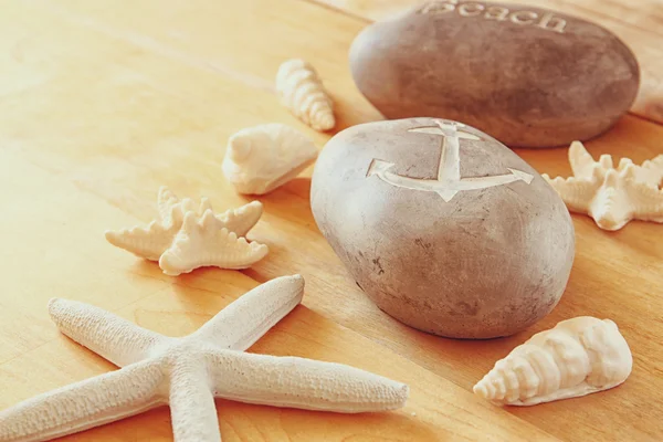 Close up of collection of nautical and beach objects  over wooden background — Stock Photo, Image