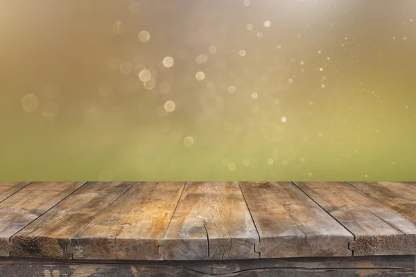 Rustic wood table in front of glitter green and gold bright bokeh lights — Stock Photo, Image