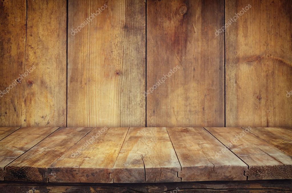 Grunge vintage wooden board table in front of old wooden background