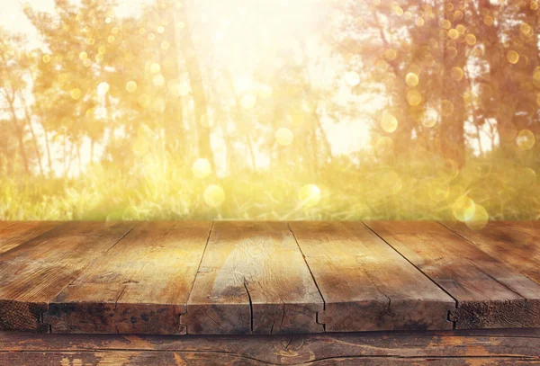 Vintage wooden board table in front of dreamy forest landscape with lens flare. — Stock Photo, Image