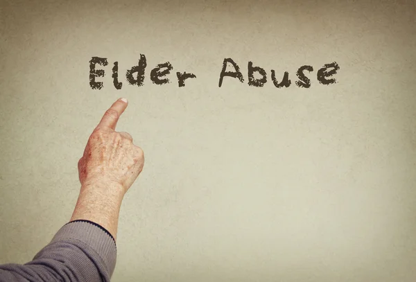 Senior man hand pointing at text with the phrase elder abuse. room for text — Stock Photo, Image