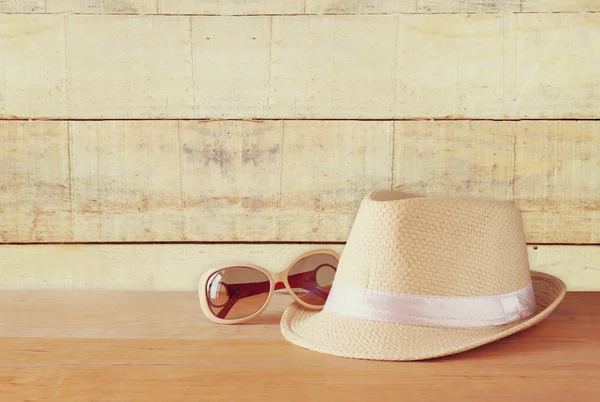 Fedora hat  over wooden table and wooden background — Stock Photo, Image