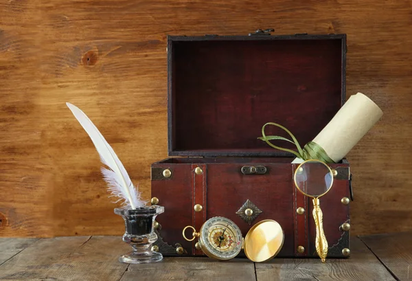 Starožitný kompas, inlwell a starou dřevěnou truhlu na dřevěný stůl — Stock fotografie