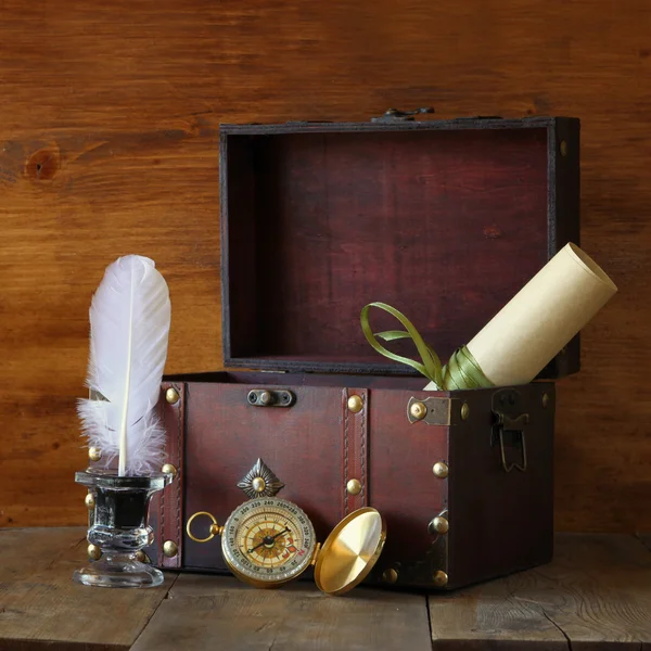 Antique compass, inkwell and old wooden chest on wooden table — Stock Photo, Image