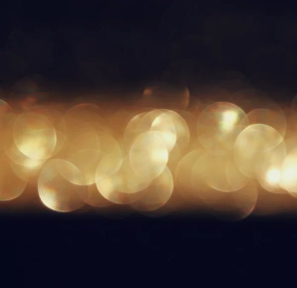 Glitter vintage lights background. dark gold and black. defocused — Stock Photo, Image