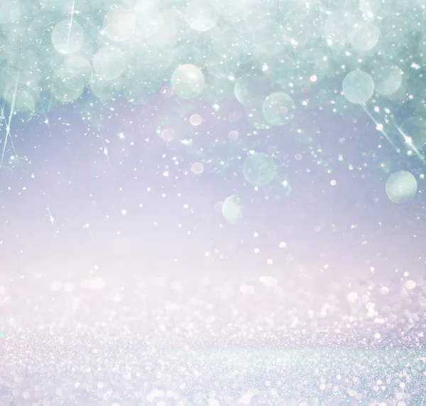 Glitter vintage lights background with light burst . silver, blue and white. de-focused. — Stock Photo, Image