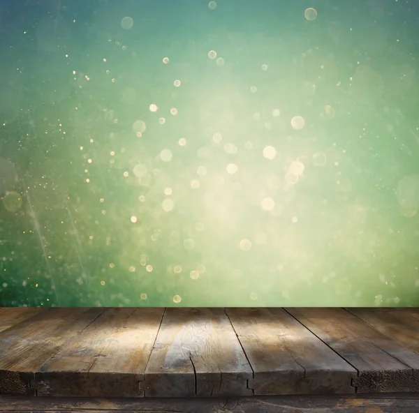 Rustic wood table in front of glitter silver, blue, and gold bokeh lights — Stock Photo, Image