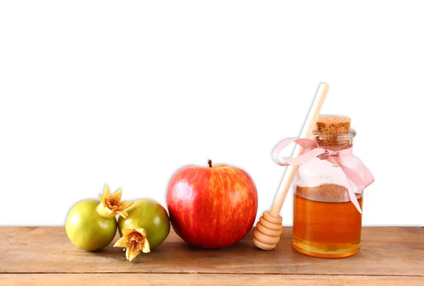 Rosh hashanah (jewesh holiday) concept - honey, apple and pomegranate over wooden table with white isolated background. traditional holiday symbols. — Stock Photo, Image