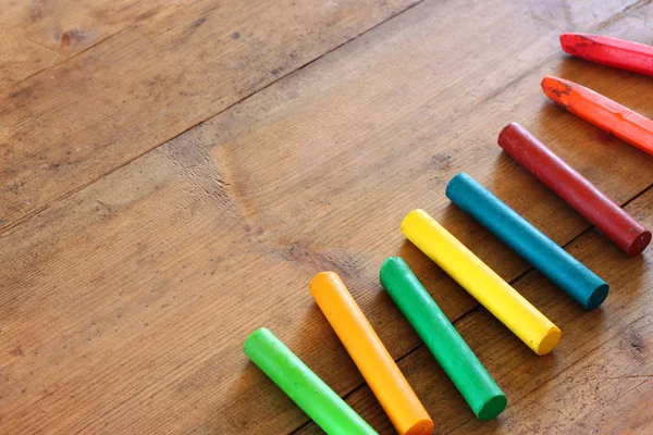 Image of various colorful crayons on wooden table — Stock Photo, Image