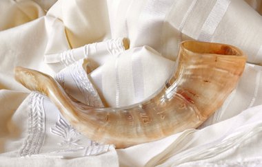 shofar (horn) on white prayer talit. rosh hashanah (jewish holiday) concept . traditional holiday symbol.